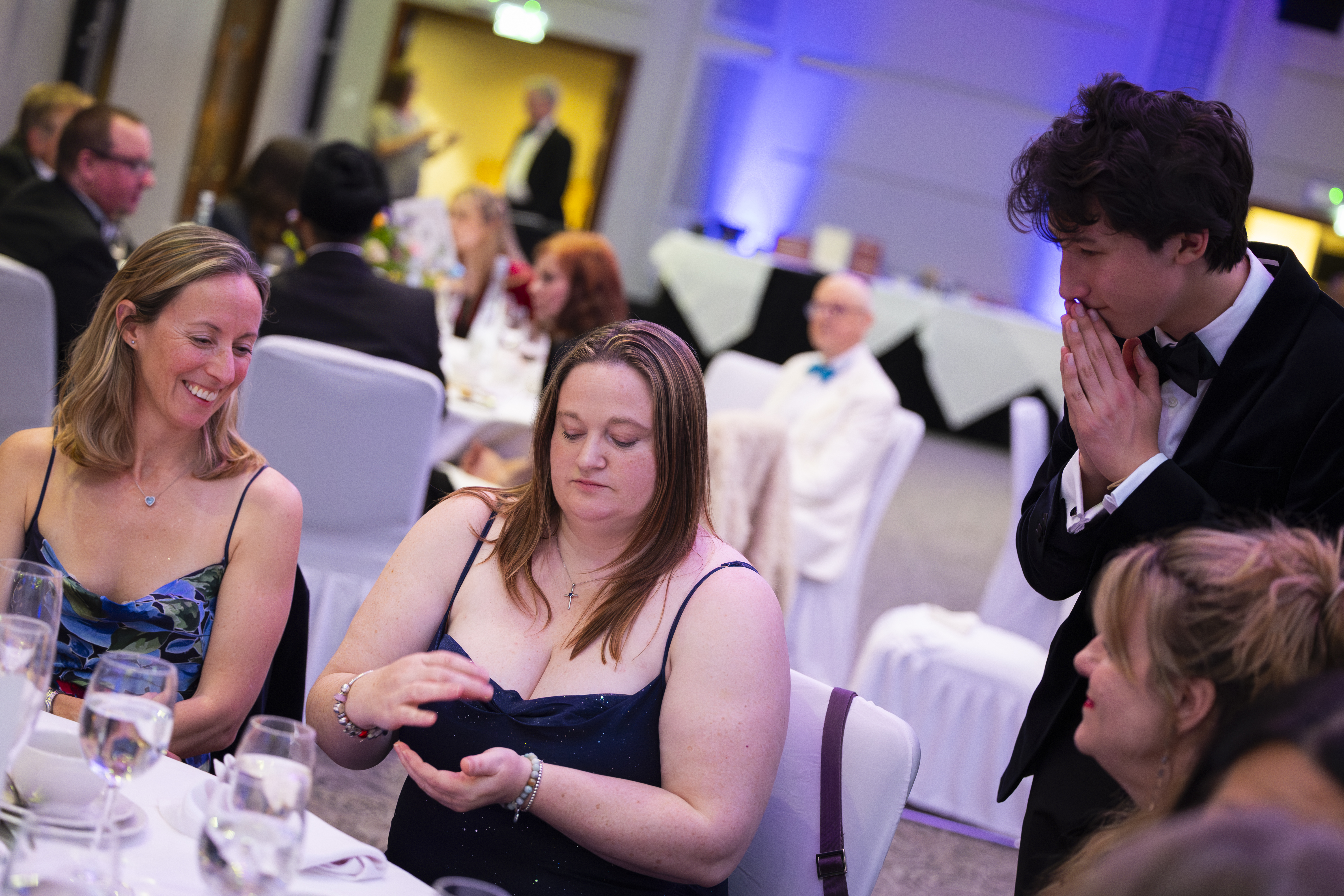 Guests watching a sleight of hand routine